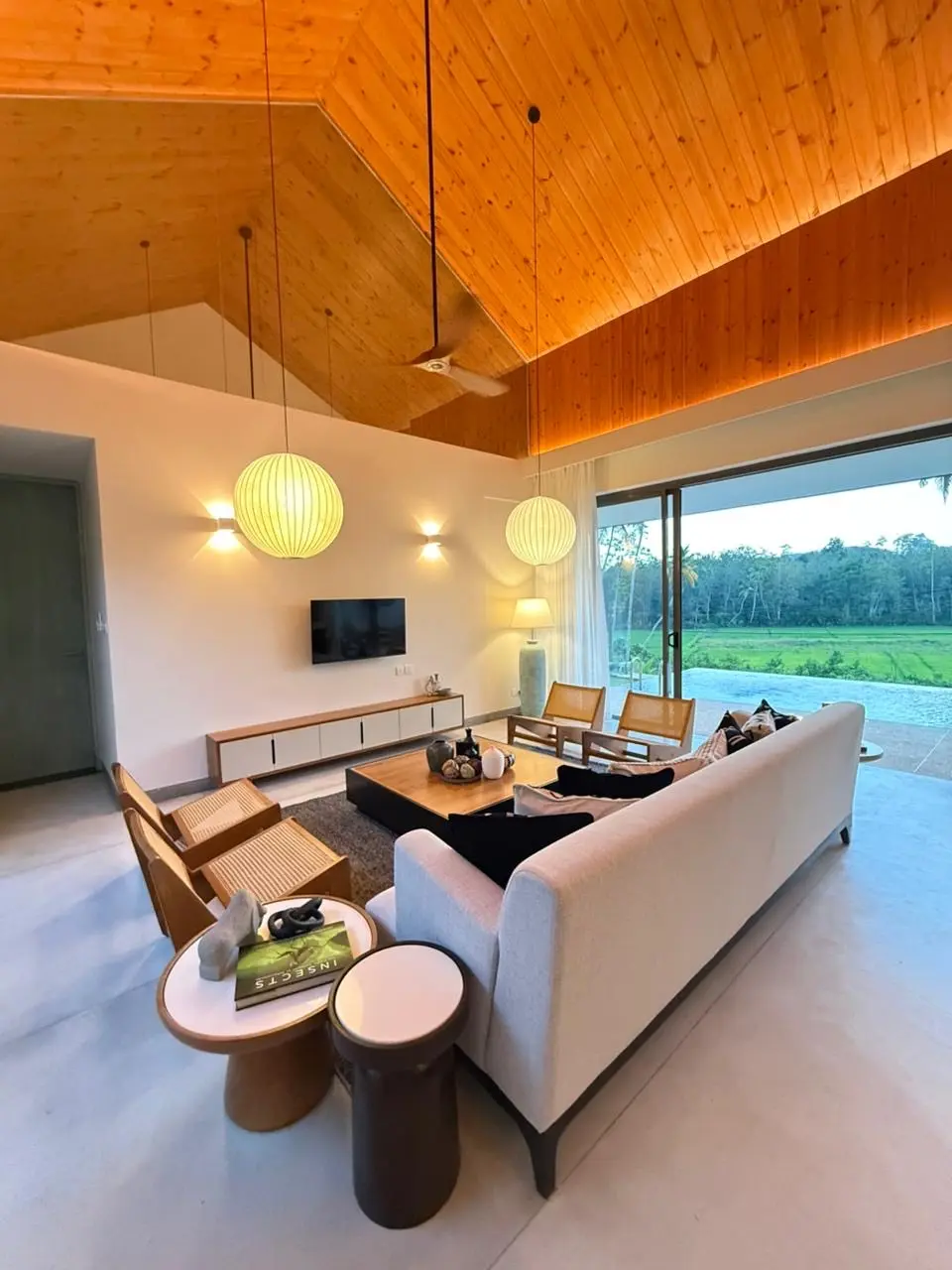 Living room with paddy field views at Hansa Villa