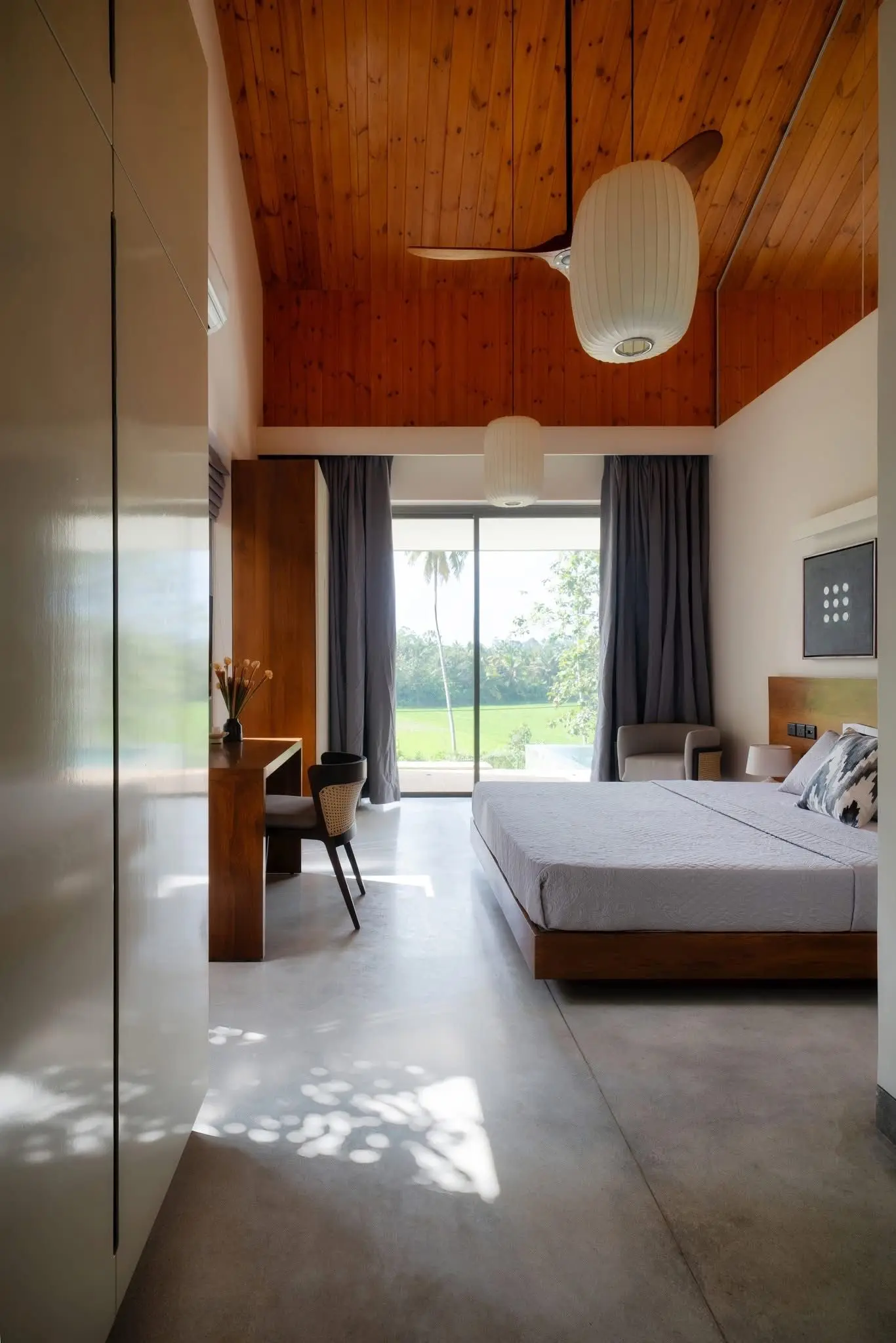 Master bedroom at Hansa Villa with views across the paddy fields