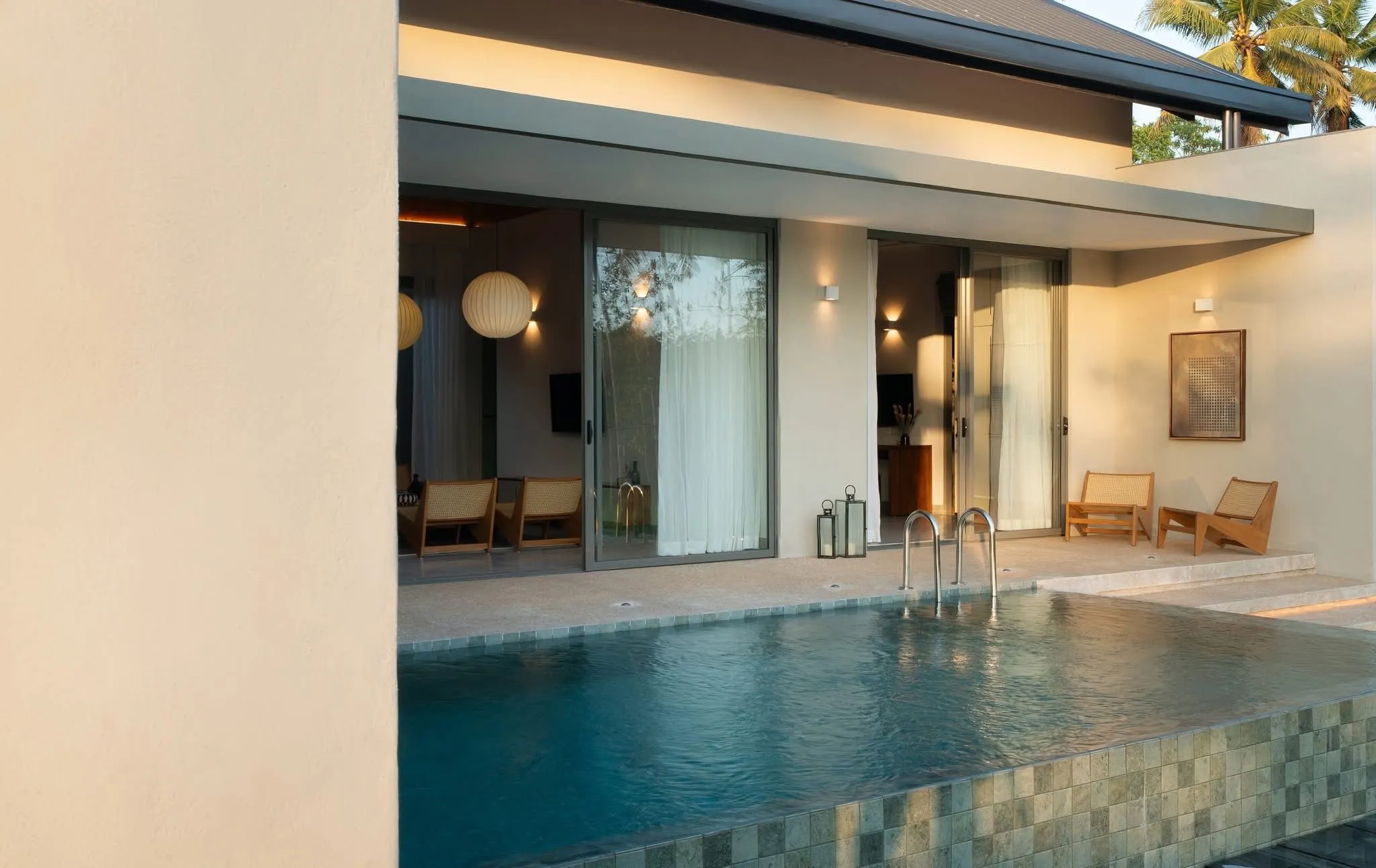 The private pool at Hansa Villa at sunset, framed by tropical planting