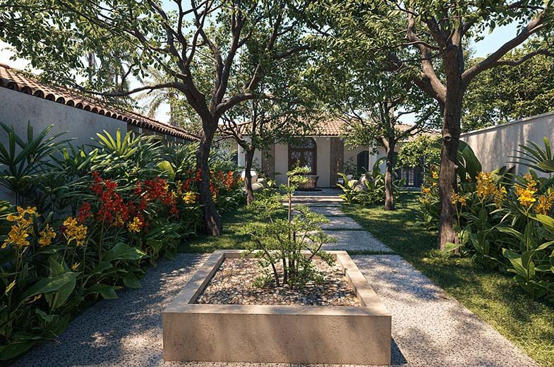 The courtyard gardens at IF Villa — stone paths and flowering shrubs beneath mature trees