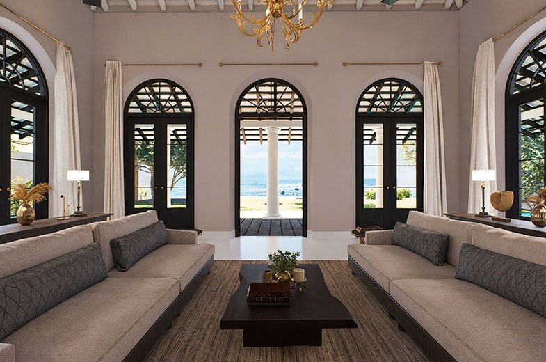 The grand lounge at IF Villa with arched windows and doors framing the ocean