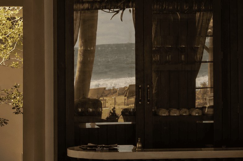 The sea-facing bar cabinet at IF Villa with the ocean beyond the glass
