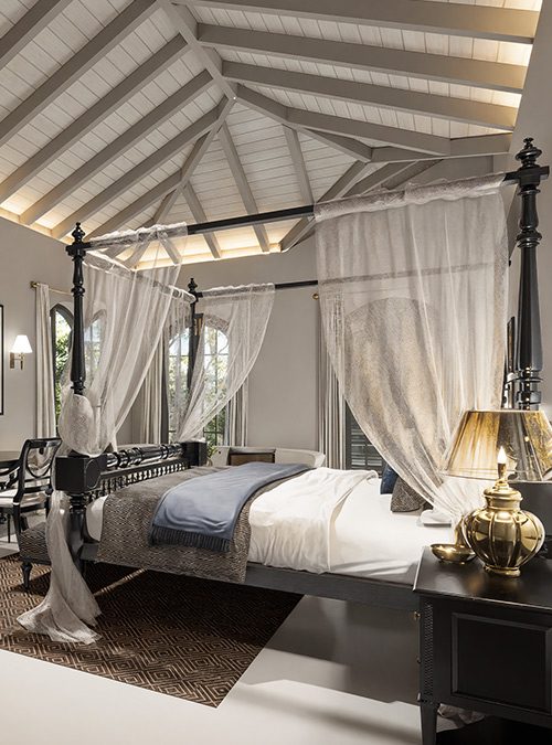 Tranquil Heritage Suite at IF Villa — four-poster bed beneath a vaulted timber ceiling