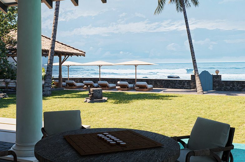 Sun loungers and umbrellas on the lawn at IF Villa facing the Indian Ocean
