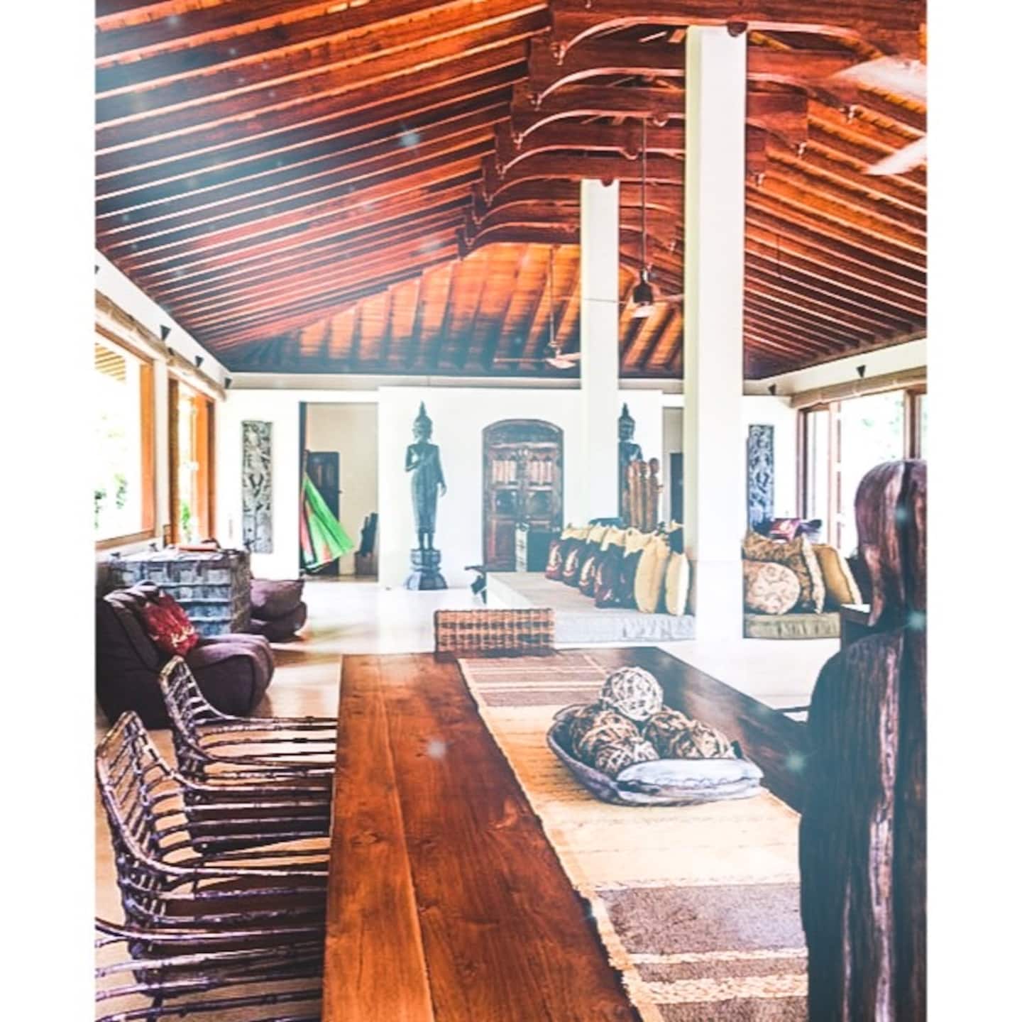 The dining hall at Kumara Luxury Villa beneath the timber cathedral ceiling
