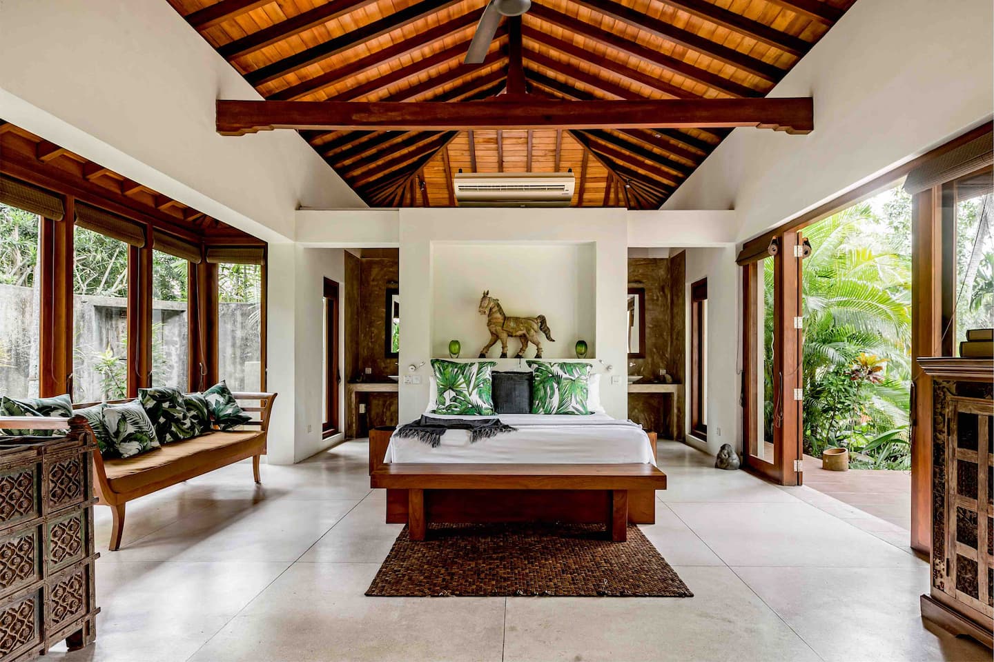Kingsize bedroom at Kumara Luxury Villa with vaulted timber ceiling opening onto the terrace