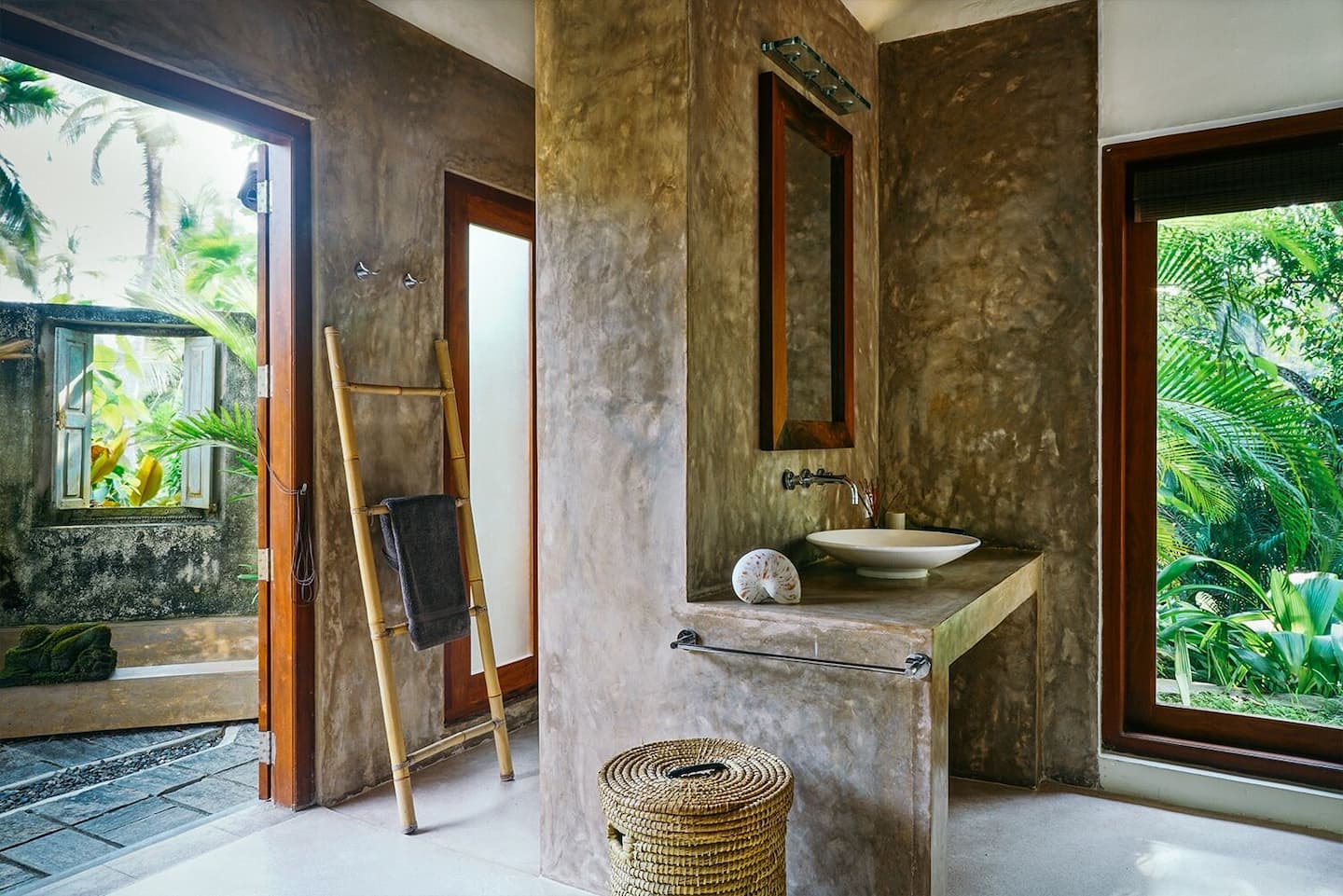 En-suite bathroom at Kumara Luxury Villa opening through double doors to the tropical garden