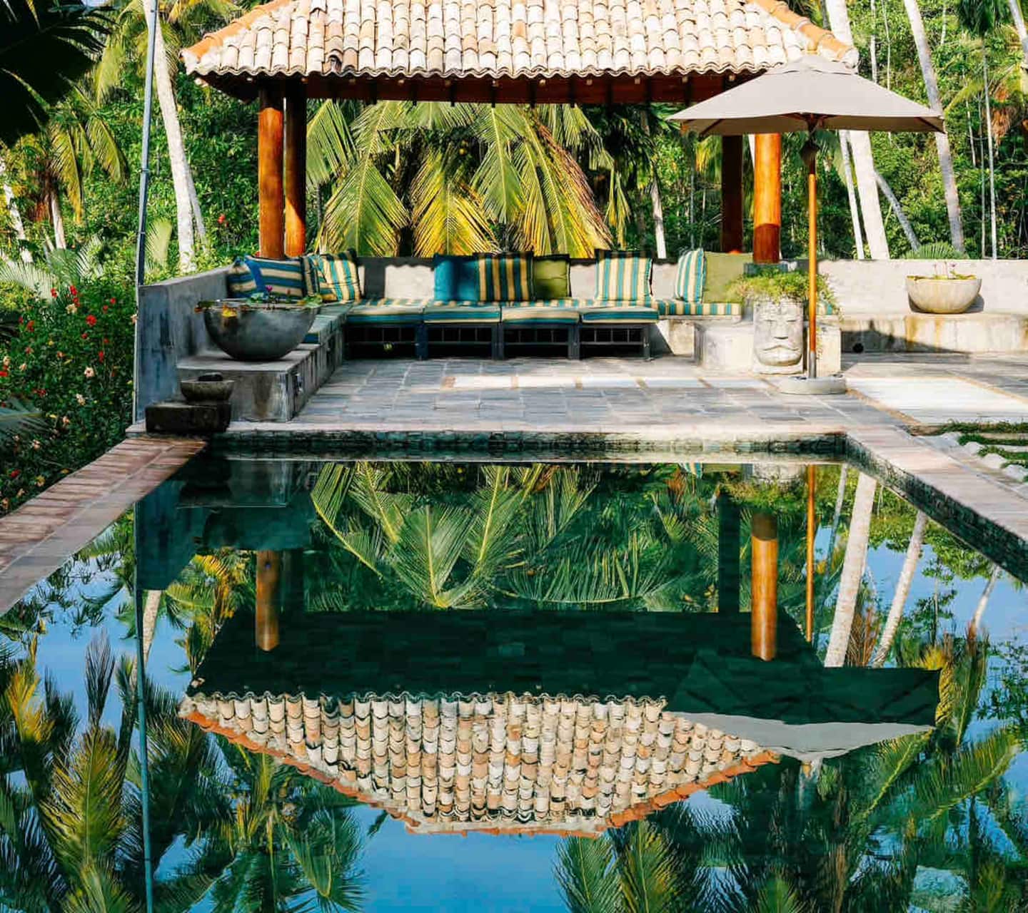 The pool pavilion at Kumara Luxury Villa with outdoor lounge seating beside the saltwater pool