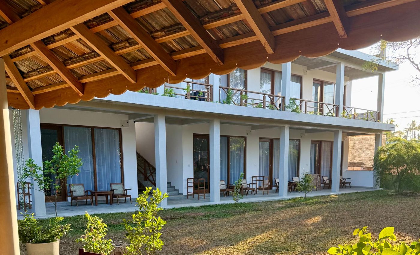 View from under the garden pavilion roofline toward the hotel rooms at Lily Mirissa