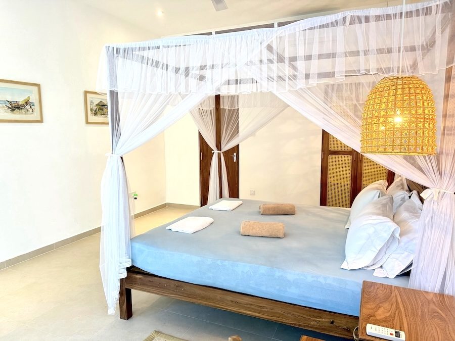 Upper-floor room at Lily Mirissa with canopy bed and bright natural light