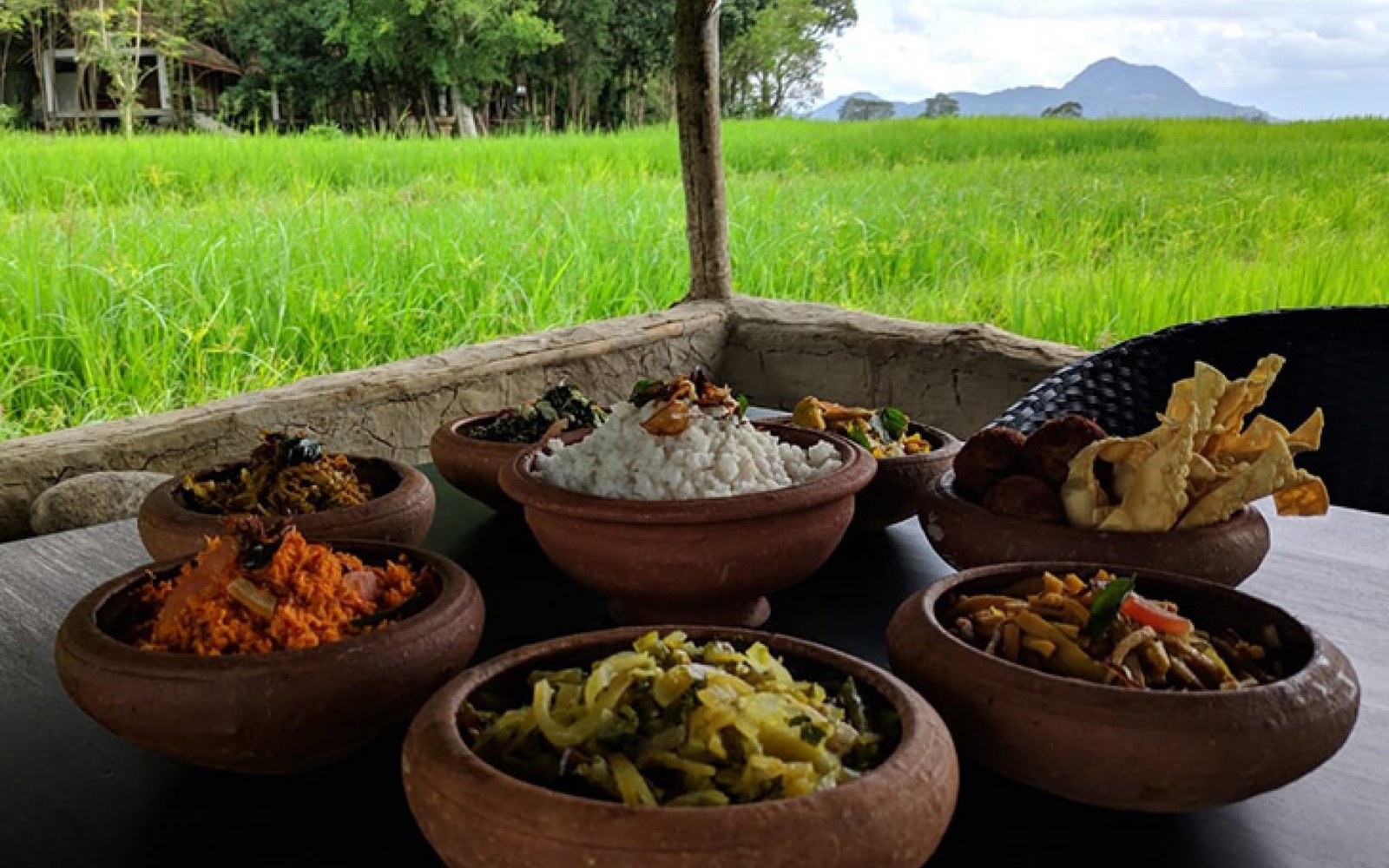 Kamatha Lunch served on a lotus leaf in the middle of a paddy field