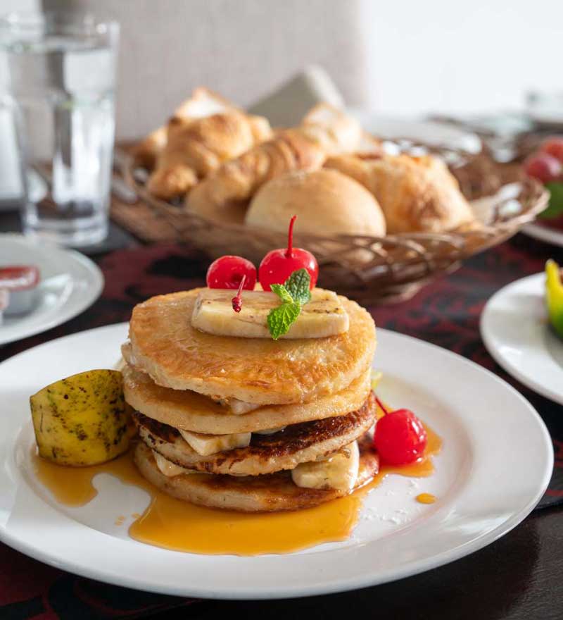 Breakfast at Mirissa Beach Villa with pancakes, fruit and fresh bread