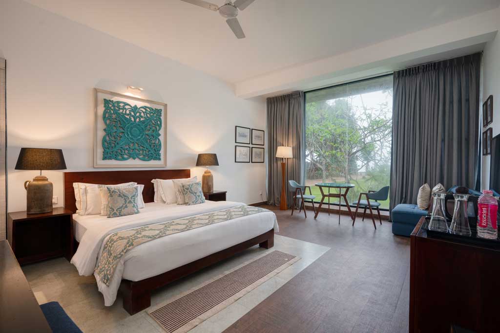 A bright, spacious bedroom at Mirissa Beach Villa with garden views