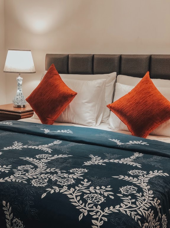 Deluxe Double Room with double bed and orange cushions