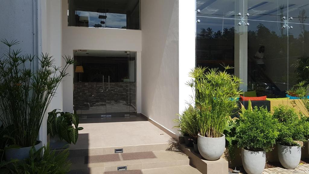 Entrance of Pinnacle Boutique Villas with glass doors and plants
