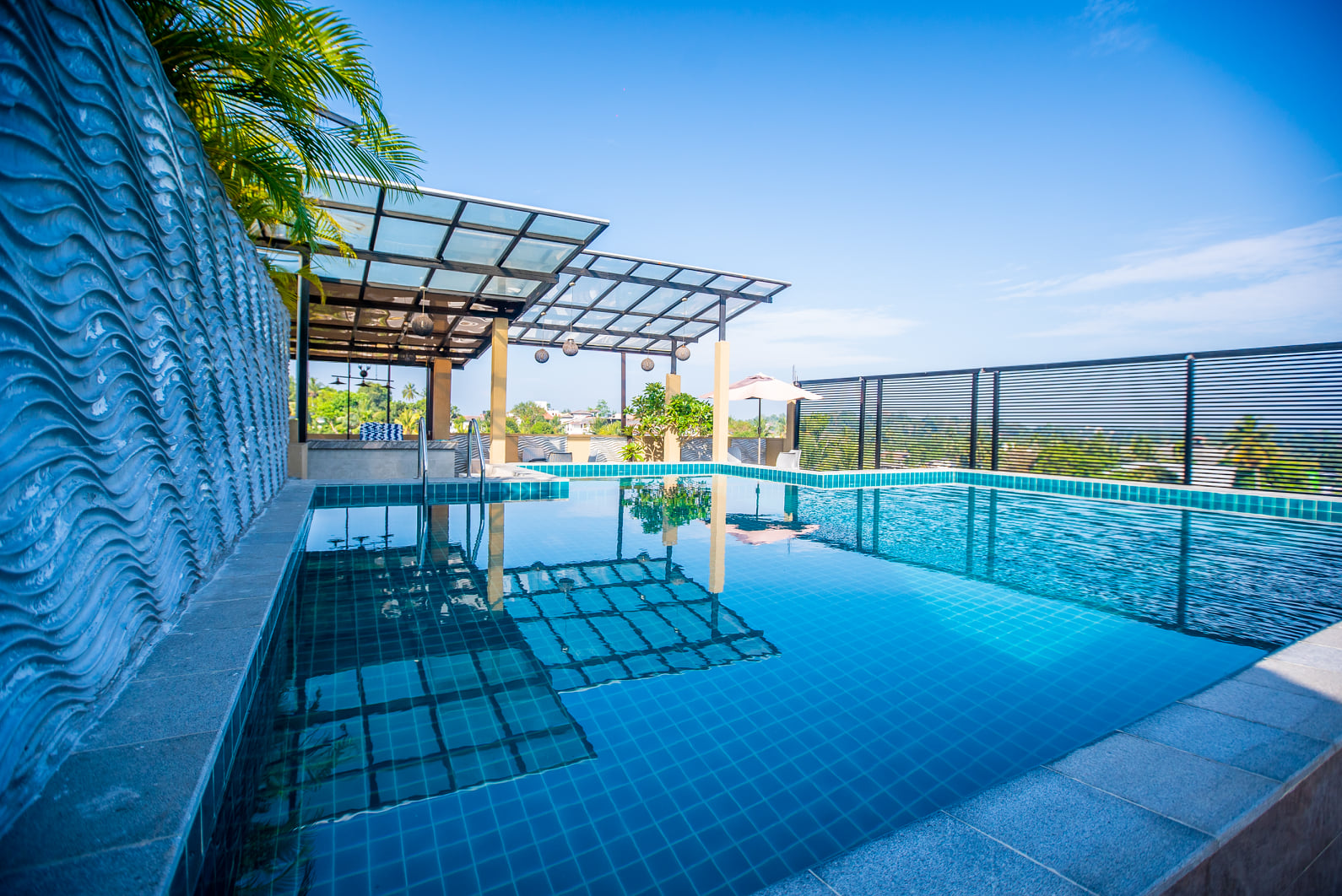 Rooftop pool at Pinnacle Boutique Villas under a clear blue sky