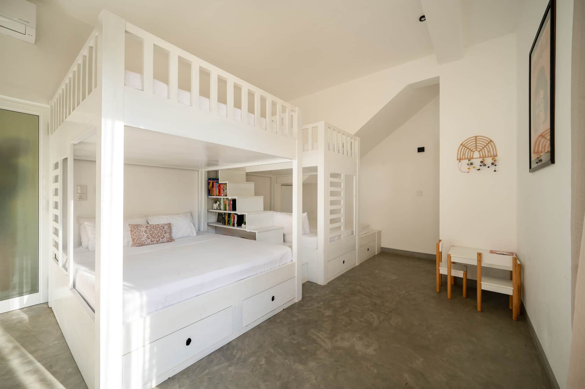 Family bunk bedroom at Sudu Villa with built-in bunk beds and bookshelves
