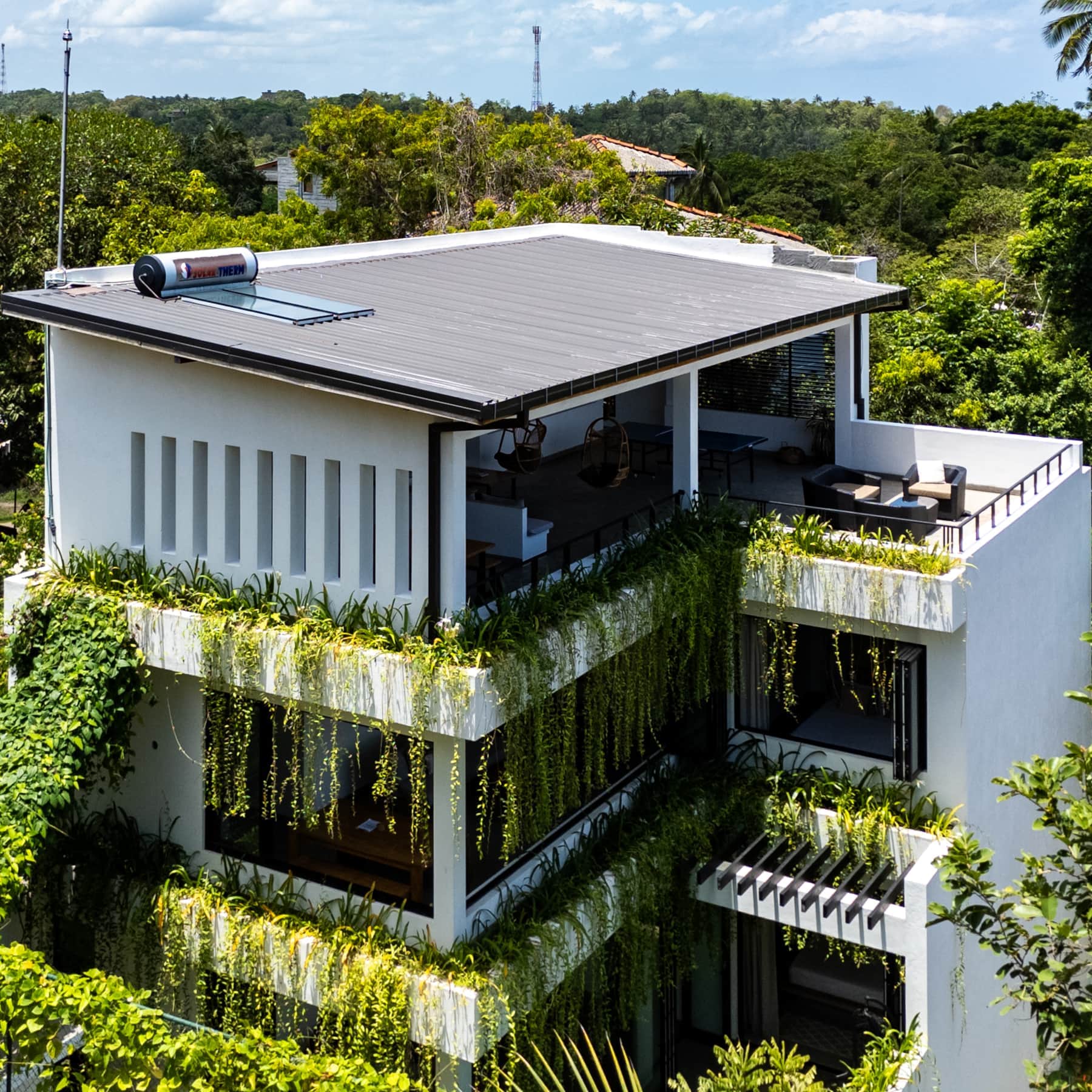 Aerial exterior of Sudu Villa showing the rooftop terrace and cascading plants