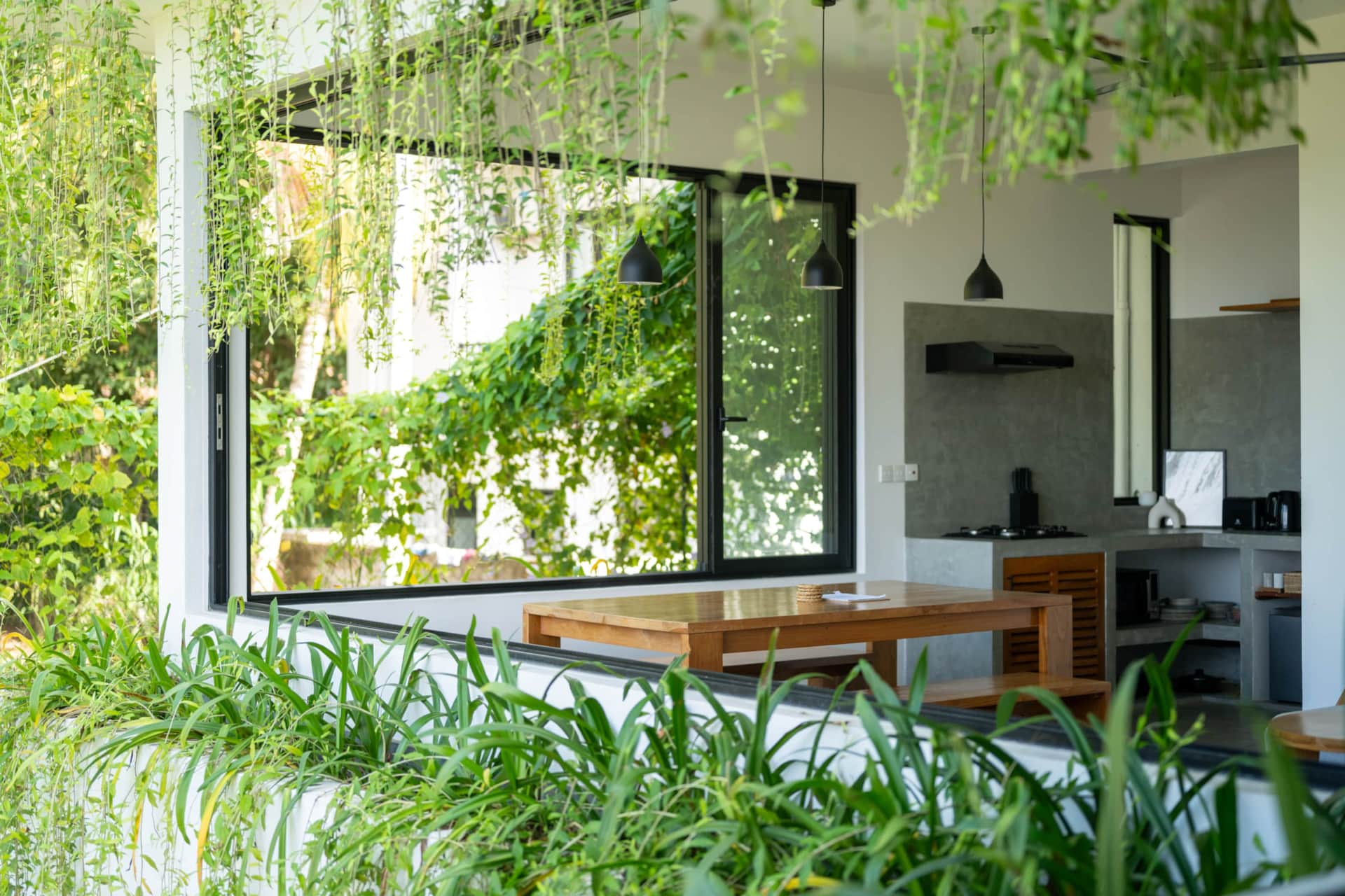 Kitchen and dining table at Sudu Villa surrounded by greenery