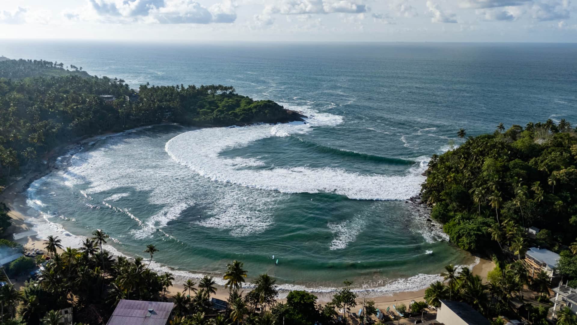 Aerial view of Hiriketiya's horseshoe bay with surf breaks