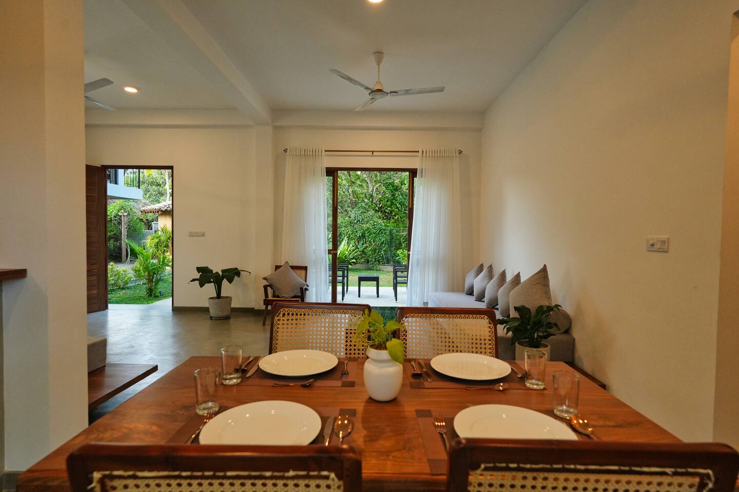 Dining area at Summer Secret with glass doors opening onto the garden