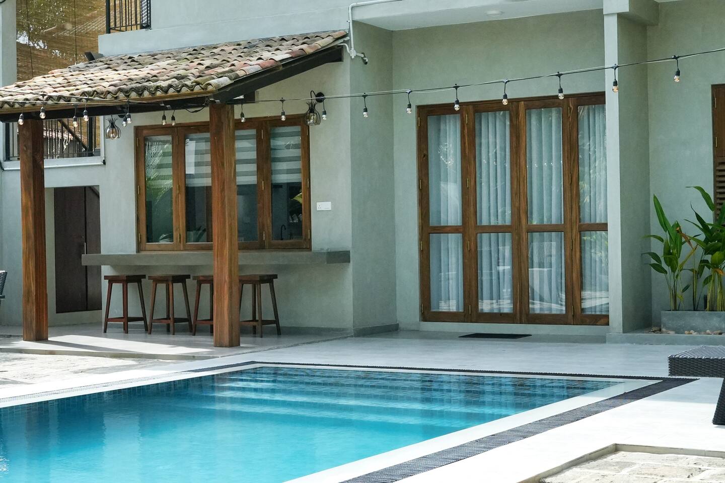 The private pool at Summer Secret with sun loungers beside the villa porch