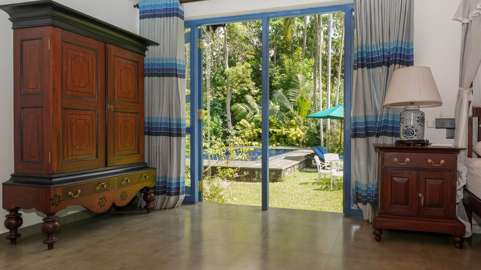 Olu — double bedroom with a view toward the pool
