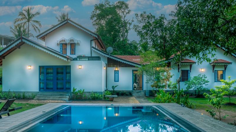Pool and villa exterior at dusk
