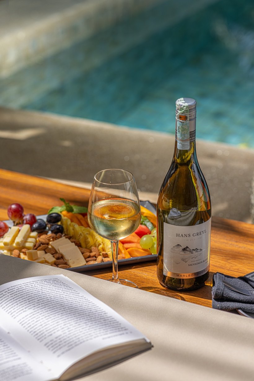 Wine and a cheese platter served beside the infinity pool at Three Gables Boutique Villa