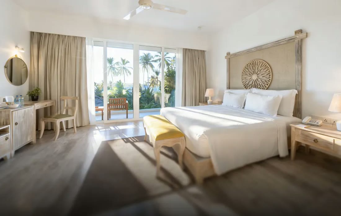 Super Deluxe Room with Balcony at Triple O Six opening onto palms and sea light