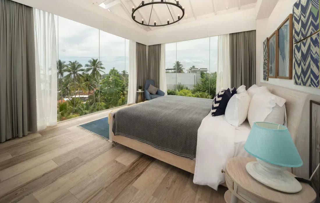 Suite Triple O Six, the Presidential Suite, with floor-to-ceiling windows over the palms