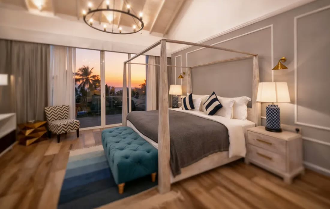 Suite Sugar at Triple O Six, a four-poster suite glowing at dusk