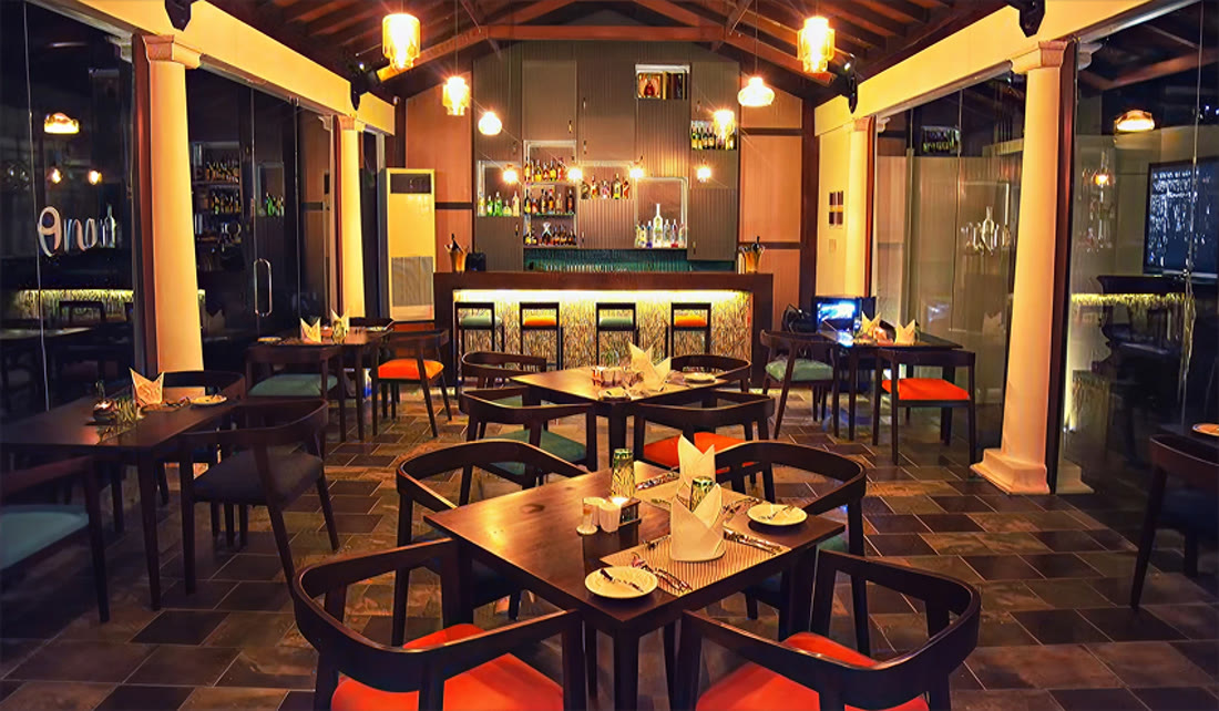 Restaurant Peri at Triple O Six — dining room and glowing bar in the evening