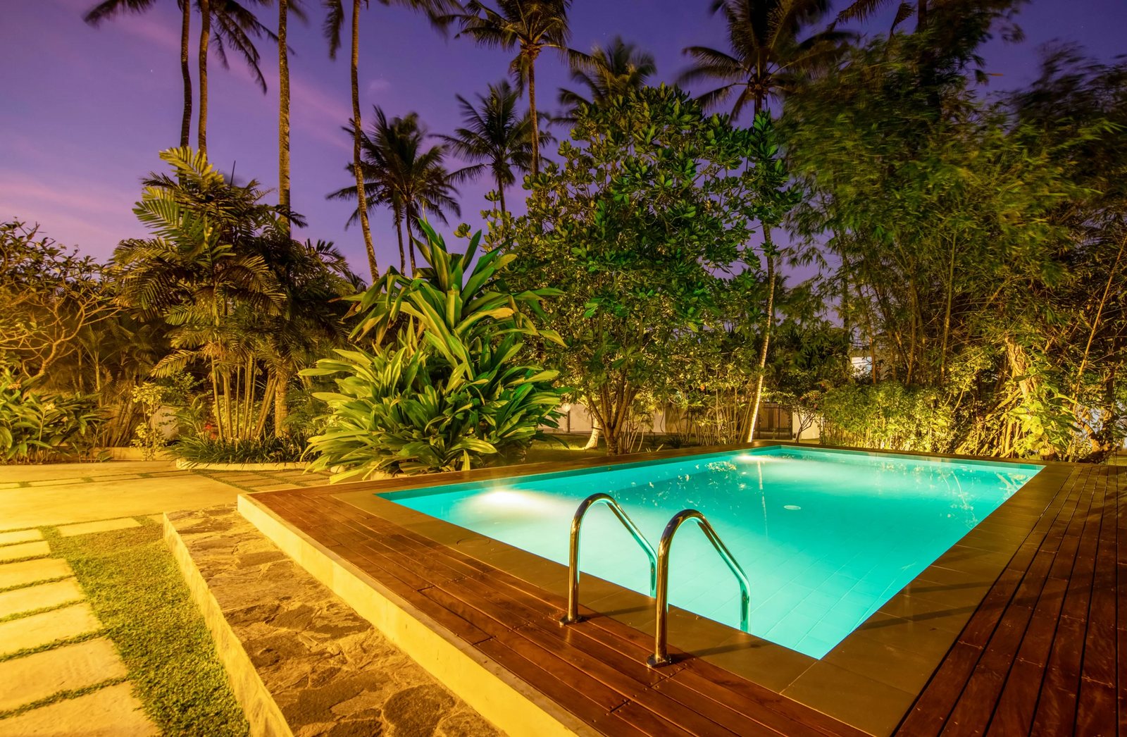Pool at night with the villa lights on